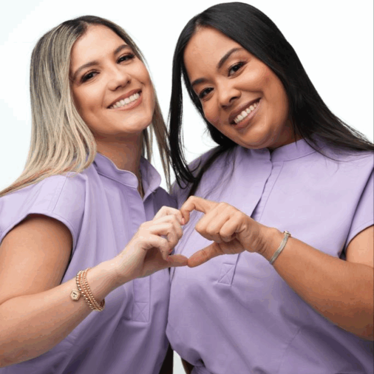 Women make a heart shape with their hands
